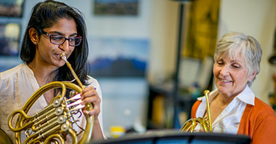 Music student playing frenchhorn
